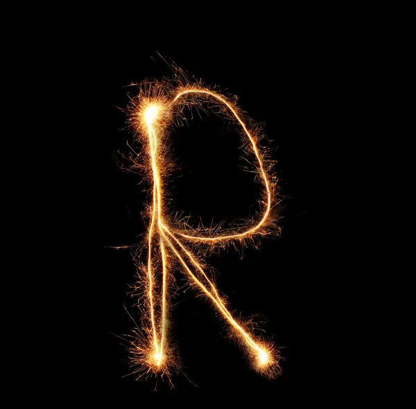 Letter "R" sparklers on black background — Stock Photo, Image