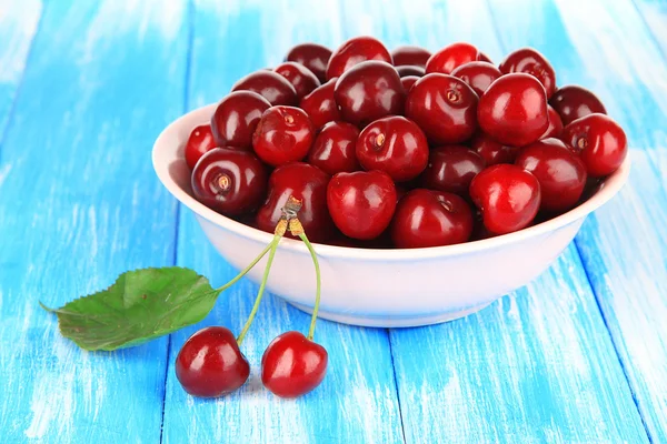 Cerises dans un bol sur une table en bois close-up — Photo