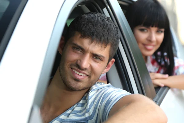 Schönes glückliches junges Paar, das Auto fährt — Stockfoto