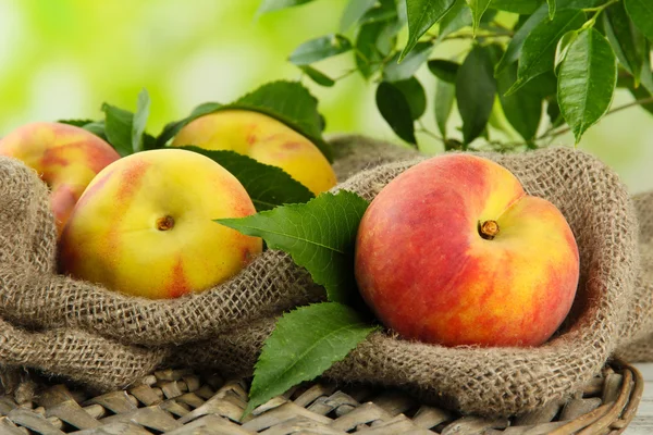 Ripe sweet peaches on wooden table in garden, close up Stock Photo