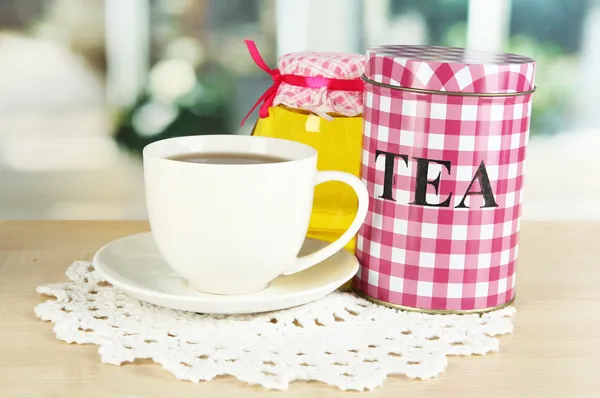 Jar and cup of tea isolated on white — Stock Photo, Image