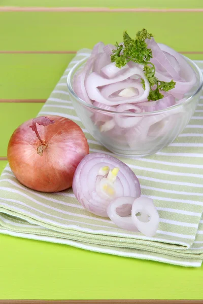 Cebola cortada com anéis na tigela na mesa de madeira close-up — Fotografia de Stock