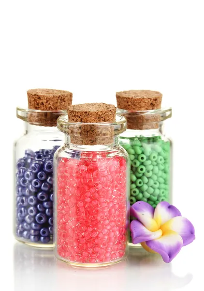 Little bottles full with colorful beads isolated on white — Stock Photo, Image