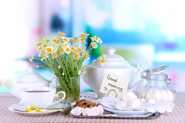 Table setting with chamomiles on wooden table on window background — Stock Photo, Image