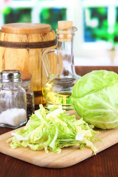 Col verde, aceite, especias en la tabla de cortar, sobre fondo brillante — Foto de Stock