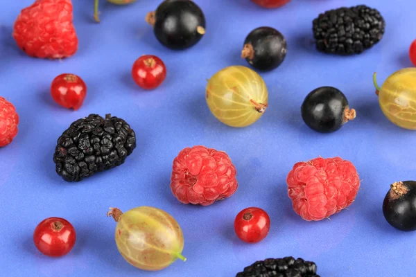 Ripe berries on blue background — Stock Photo, Image