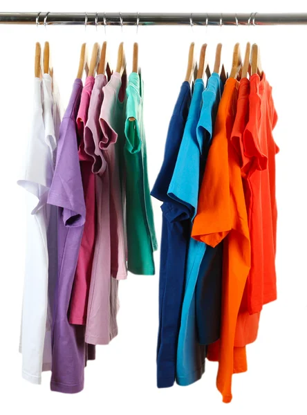 Choice of clothes of different colors on wooden hangers, isolated on white — Stock Photo, Image