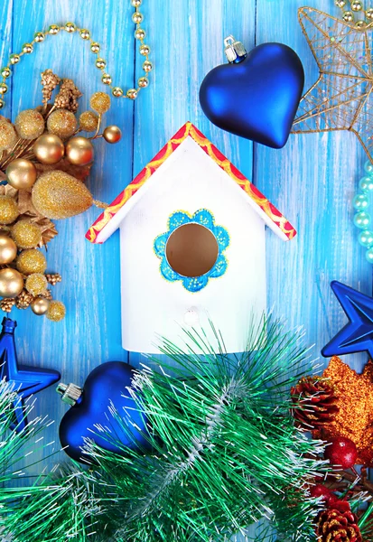 Nesting box and Christmas decorations on blue background — Stock Photo, Image