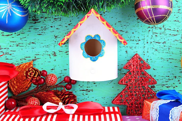 Nesting box and Christmas decoration on blue background — Stock Photo, Image