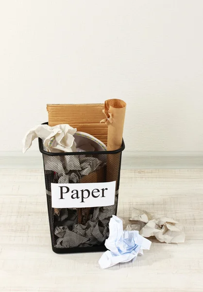 Assorted trash in bucket on room background — Stock Photo, Image