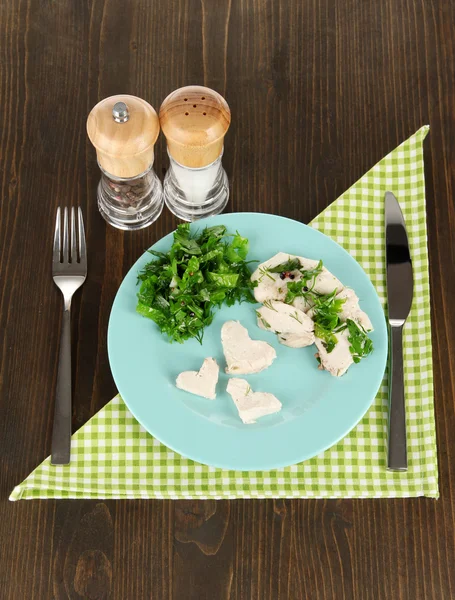 Boiled meat on plates on wooden table — Zdjęcie stockowe