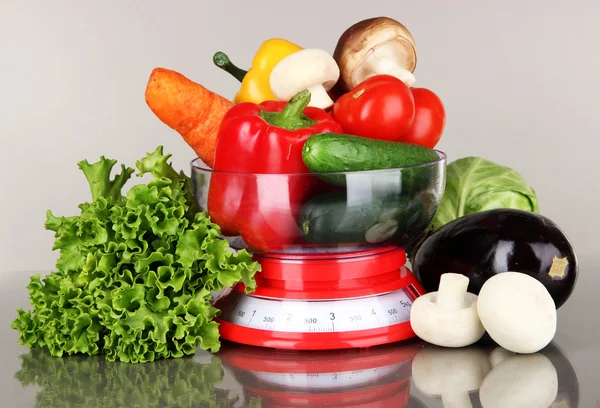 Fresh vegetables in scales on gray background — Stock Photo, Image