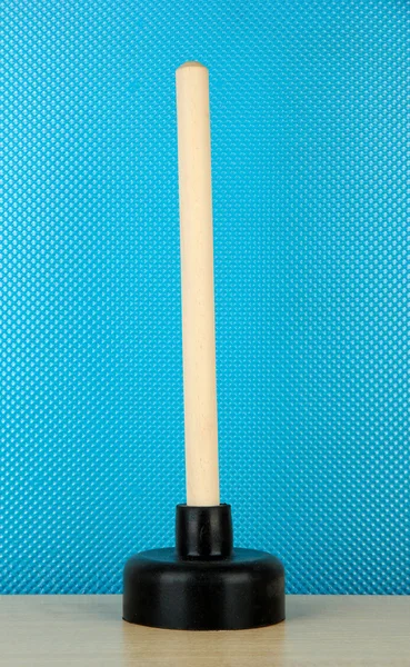 Toilet plunger on blue background — Stock Photo, Image