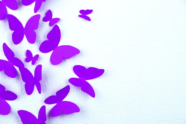 Paper butterflies fly on wall in different directions — Stock Photo, Image