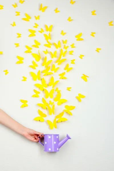 Paper yellow butterflies fly out of watering can — Stock Photo, Image