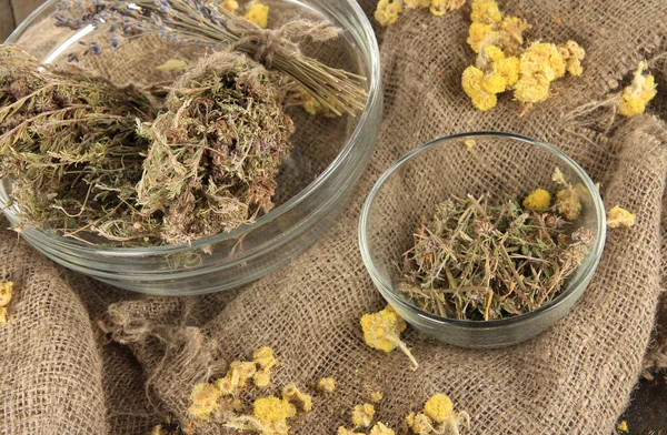 Medicinal Herbs in glass bowls on bagging close-up — Stock Photo, Image