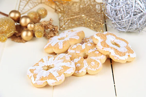 Christmas cookies and decorations on color wooden background — Stock Photo, Image