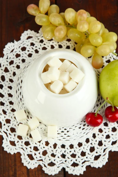 Refined sugar in white sugar bowl on wooden background — Stock Photo, Image