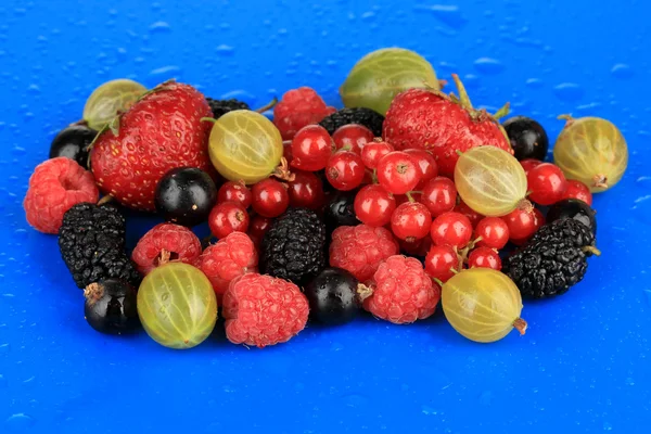 Ripe berries on blue background — Stock Photo, Image