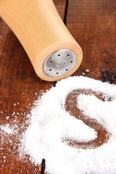 Wooden salt shaker on wooden background — Stock Photo, Image