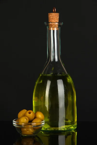 Original glass bottle with oil on dark color background — Stock Photo, Image