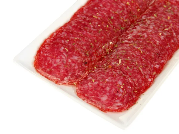 Smakelijke salami op plaat geïsoleerd op wit — Stockfoto