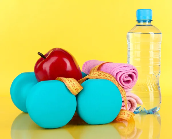 Dumbbells on yellow background — Stock Photo, Image