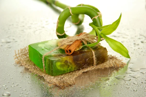 Hand-made soap and bamboo with drops, close up — Stock Photo, Image