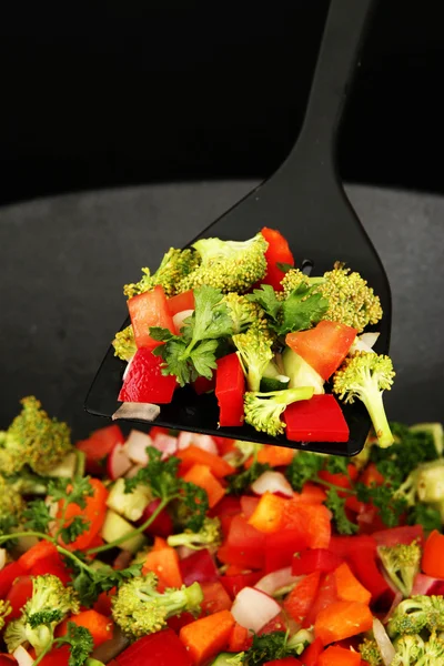 Vegetable ragout in wok, isolated on black — Stock Photo, Image