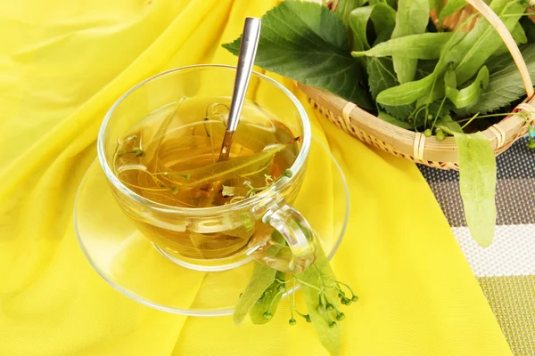 Glass cup of tea with linden on napkin close-up — Stock Photo, Image