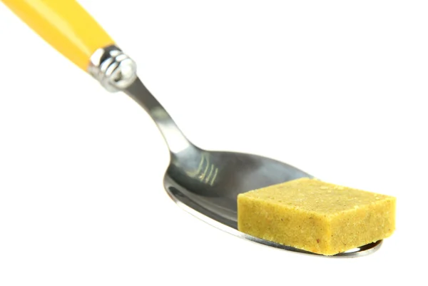 Bouillon cube on spoon, isolated on white — Stock Photo, Image