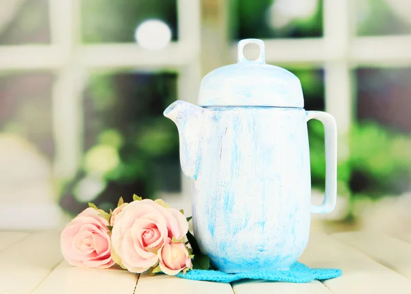 Antique white teapot on wooden table on window background — Stock Photo, Image