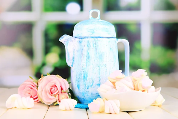 Antique white teapot on wooden table on window background — Stock Photo, Image