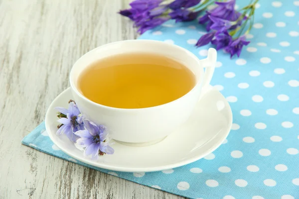 Cup of tea with chicory, on wooden background — Stock Photo, Image