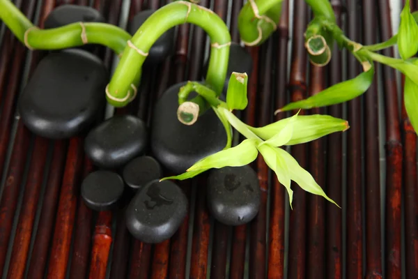 Spa stones and bamboo on bamboo mat background — Stock Photo, Image