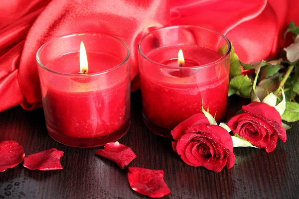 Beautiful romantic red candle with flowers, close up — Stock Photo, Image