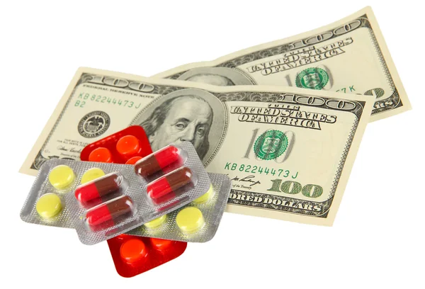 Pillen en geld geïsoleerd op wit — Stockfoto
