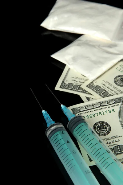 Drugs, money and syringes, isolated on black — Stock Photo, Image