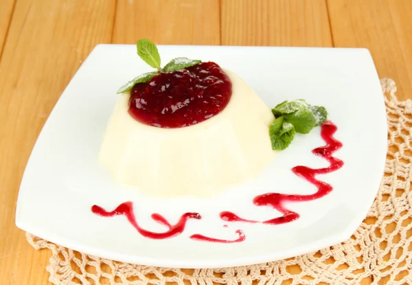 Panna Cotta with raspberry sauce, on wooden background — Stock Photo, Image