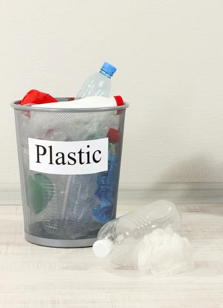 Assorted trash in bucket on room background — Stock Photo, Image