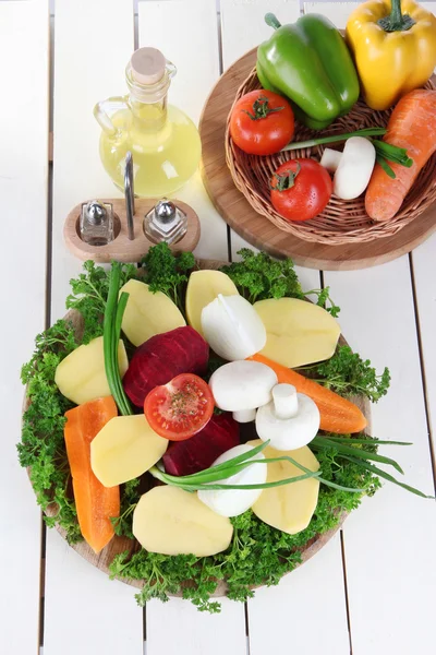 Many peeled vegetables on wooden background — Stock Photo, Image
