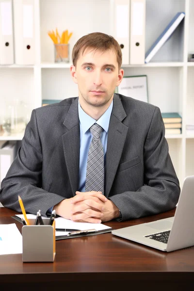 Young businessman in office at his workplace — Stock Photo, Image