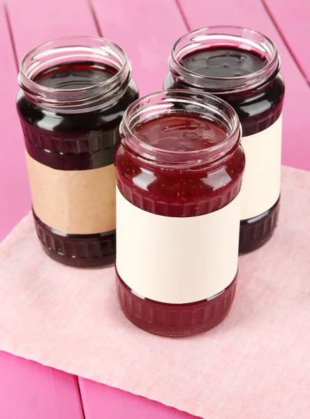 Tasty jam in banks on table — Stock Photo, Image