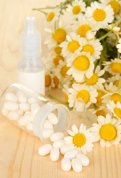 Medicine chamomile flowers on wooden table — Stock Photo, Image