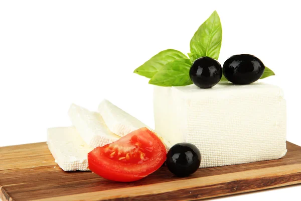 Sheep milk cheese with basil and black olives, tomato on cutting board, isolated on white — Stock Photo, Image