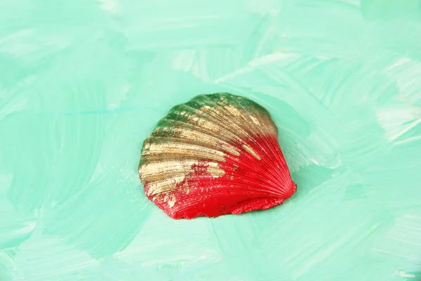 Colorful seashell on color wooden background — Stock Photo, Image