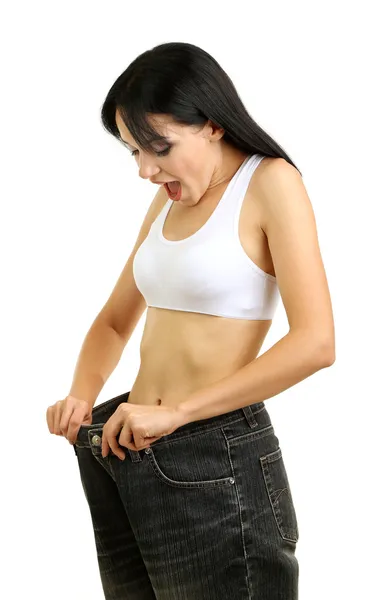 Belle jeune femme avec de gros jeans isolés sur blanc — Photo