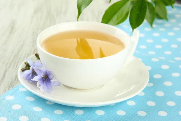 Cup of tea with chicory, on wooden background — Stock Photo, Image