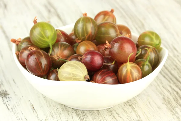 Fresh gooseberries in bowl on table close-up Stock Photo