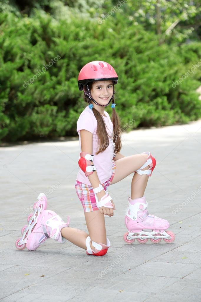 Little girl in roller skates at park Stock Photo by ©belchonock 27241895
